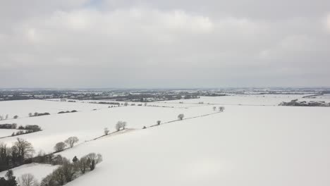 aerial shot advance forward vast blanket of white untouched snow ahead