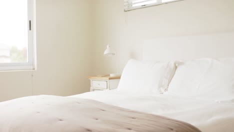 general view of bedroom with pillows on double bed, slow motion