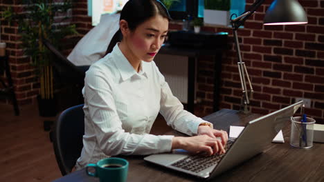 employee typing on laptop, solving tasks, communicating with business partners