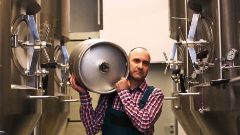 brewer carrying keg at brewery