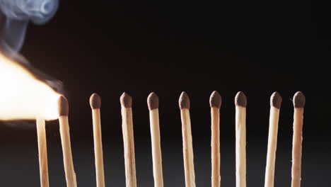 Video of matches with yellow fire flame and copy space on black background