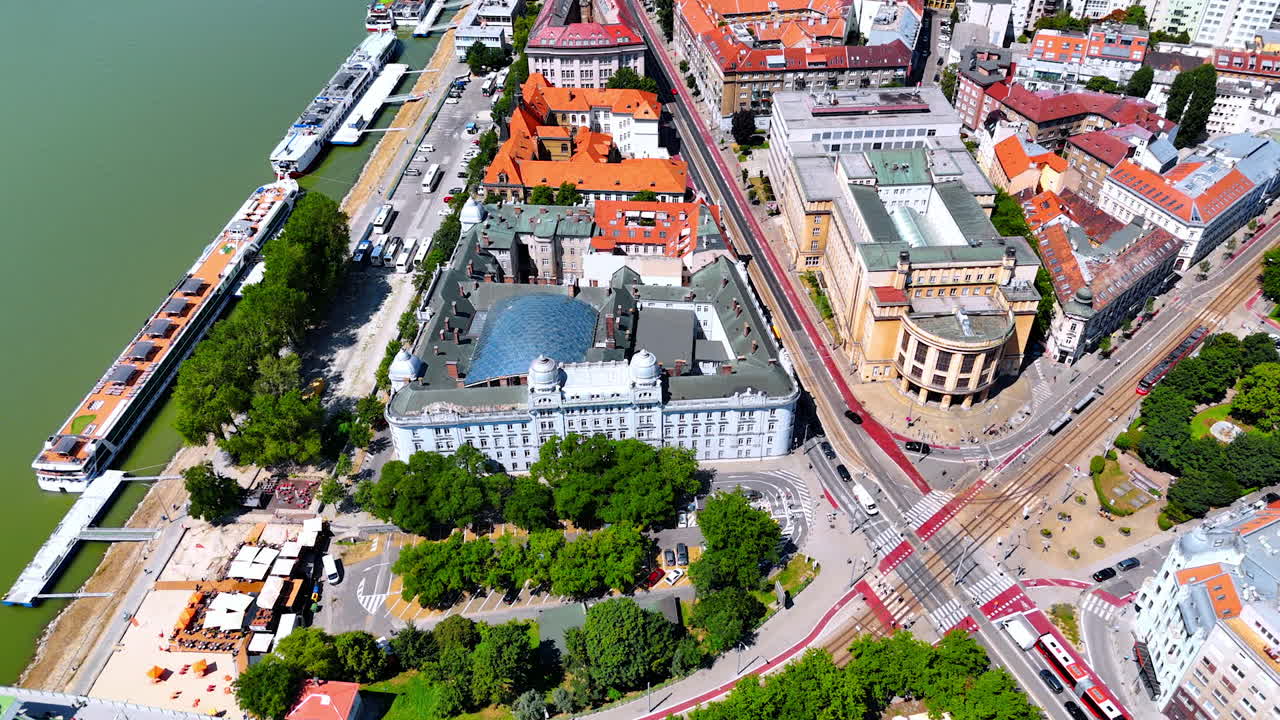 Waterfront of the Danube River in Bratislava, Slovakia. Aerial perspective on the orange roofs of historical buildings.