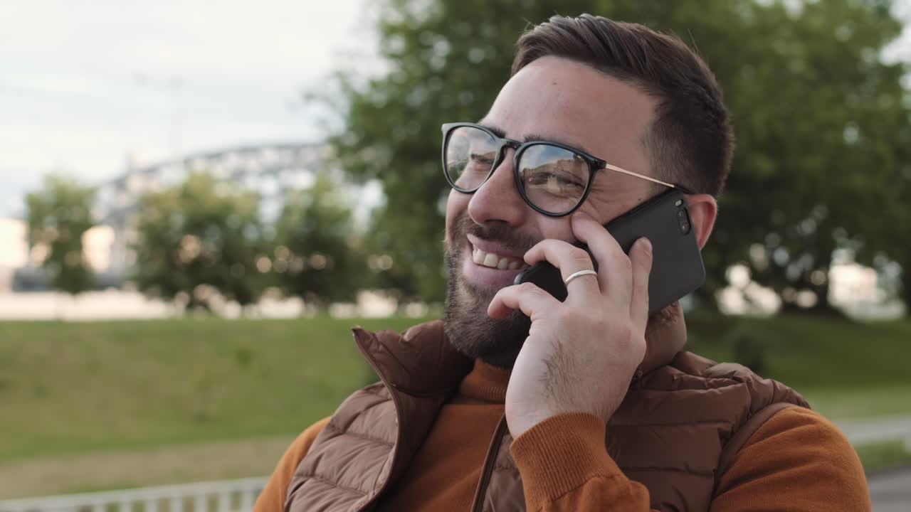 Man Talking on Smartphone Outdoors