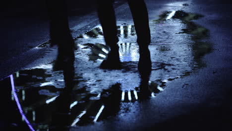 Reflection-of-unknown-people-running-on-puddle.-Mirroring-of-ferris-wheel.