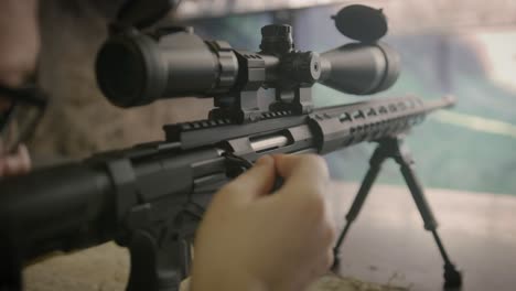 shooter reloading sniper rifle at shooting range, close up on weapon