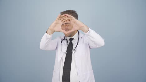 doctor making heart looking at camera.