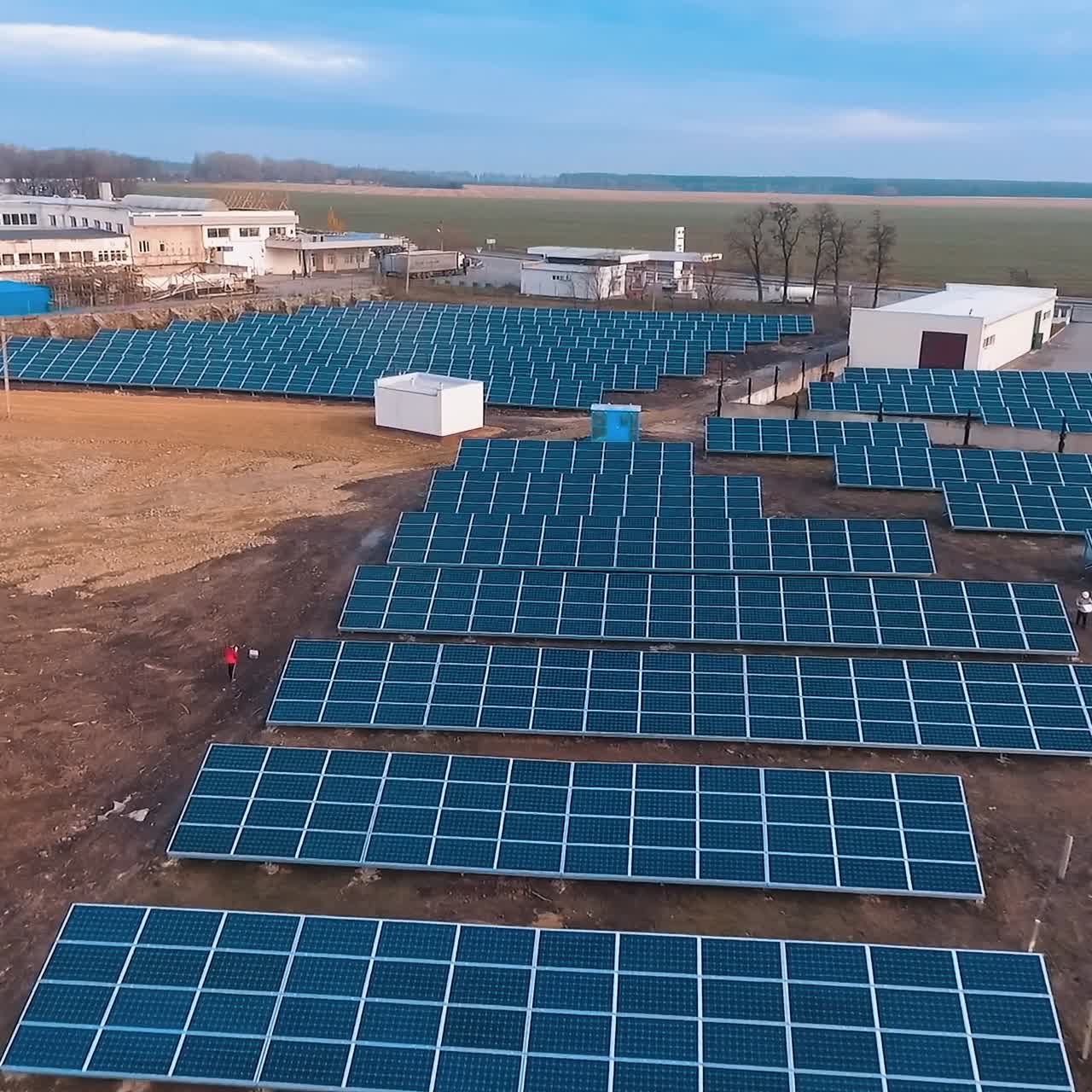 Solar power plant on the field. Innovative solar batteries among nature. Production of clean alternative energy. Aerial view.
