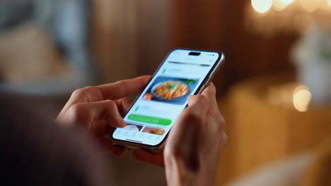 person using a food app on a smartphone