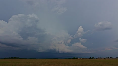 Amazing-storm-clouds-formed-above-agriculture-field,-time-lapse