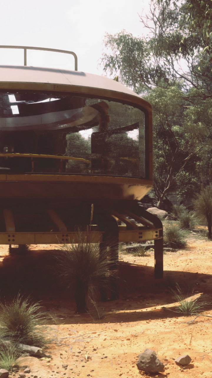 Ufo shaped structure near rocks and plants during daytime in desert area