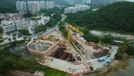 panning drone shot over a construction site within a city