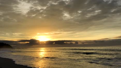las olas del océano golpean la playa en un amanecer en costa rica