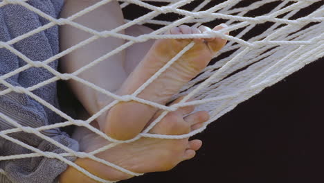 closeup of a woman’s feet on a hammock