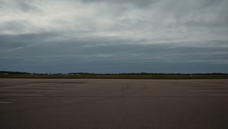 empty asphalt parking lot under a cloudy sky