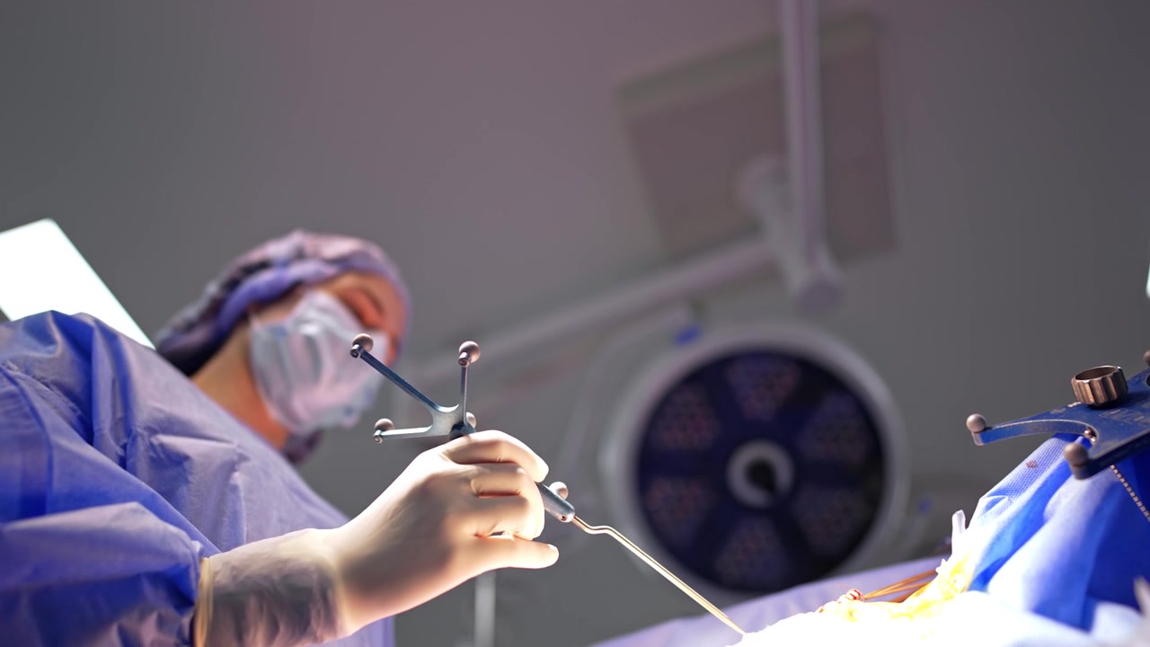 Woman holds a metal probe for brain exploration. Low angle view. Neurosurgery concept.