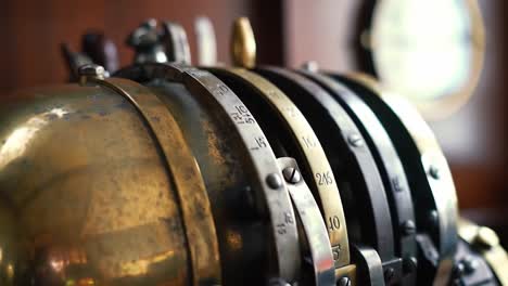 brass cash register sits atop a wooden counter in a charming shop, showcasing intricate details and the beauty of vintage machinery. a glimpse into the past is captured in this unique setting.