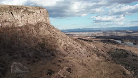 aerial, dolly zoom shot about shadows of clouds threateningly creeping over the empty, romanian landscape at winter