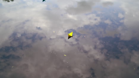 A paper boat sails along the river.