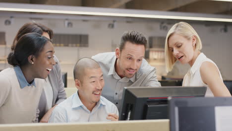 diverse team of business people working late brainstorming around computer touchscreen