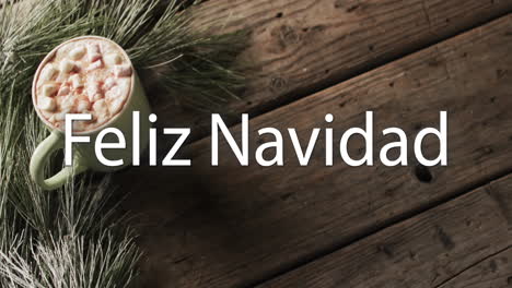 feliz navidad text in white over christmas hot chocolate on wood background
