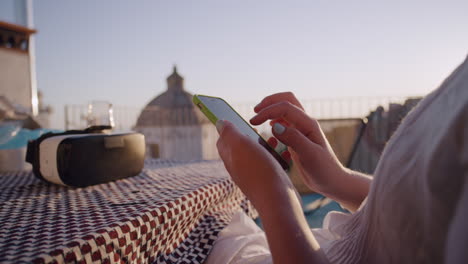 young-woman-using-smartphone-browsing-online-sending-text-messages-enjoying-sharing-summer-vacation-experience-relaxing-on-balcony-in-rustic-villa-close-up-virtual-reality