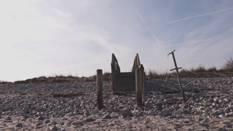 wooden bridge on a german beach with the blue sky in the background