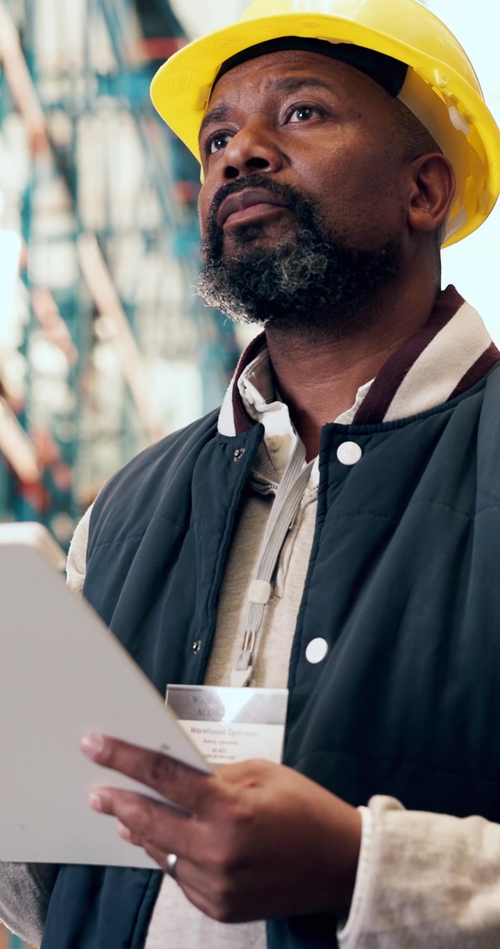 Warehouse Worker Reviewing Inventory on Clipboard