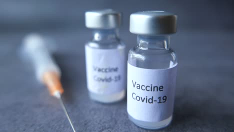 covid-19 vaccine vials and syringe