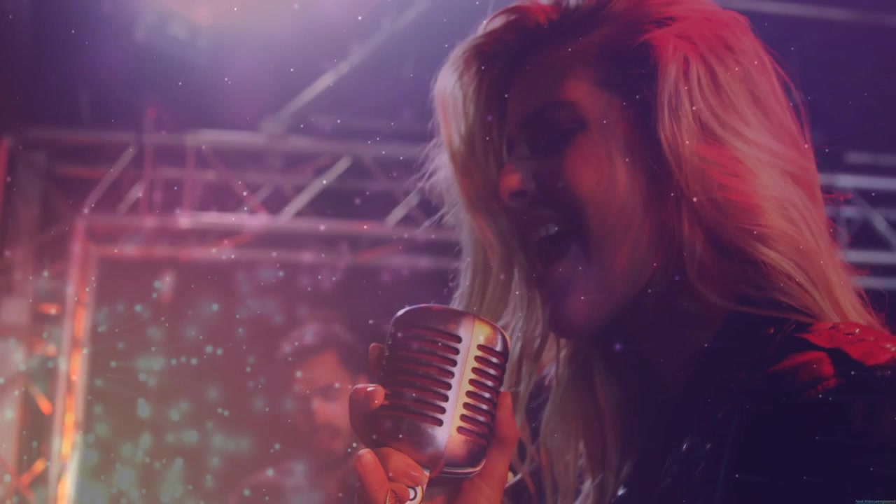 Female singer starting vocal line, pulling camera close, singing into vintage mic for performance