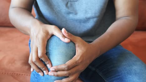 man holding his knee in pain