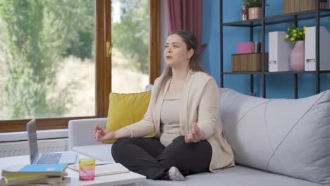 Young-woman-doing-yoga-outside-in-front-of-the-window.