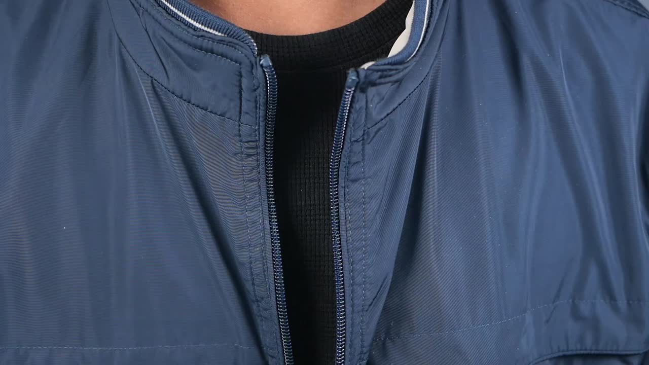 Close-up of a blue jacket with a zipper