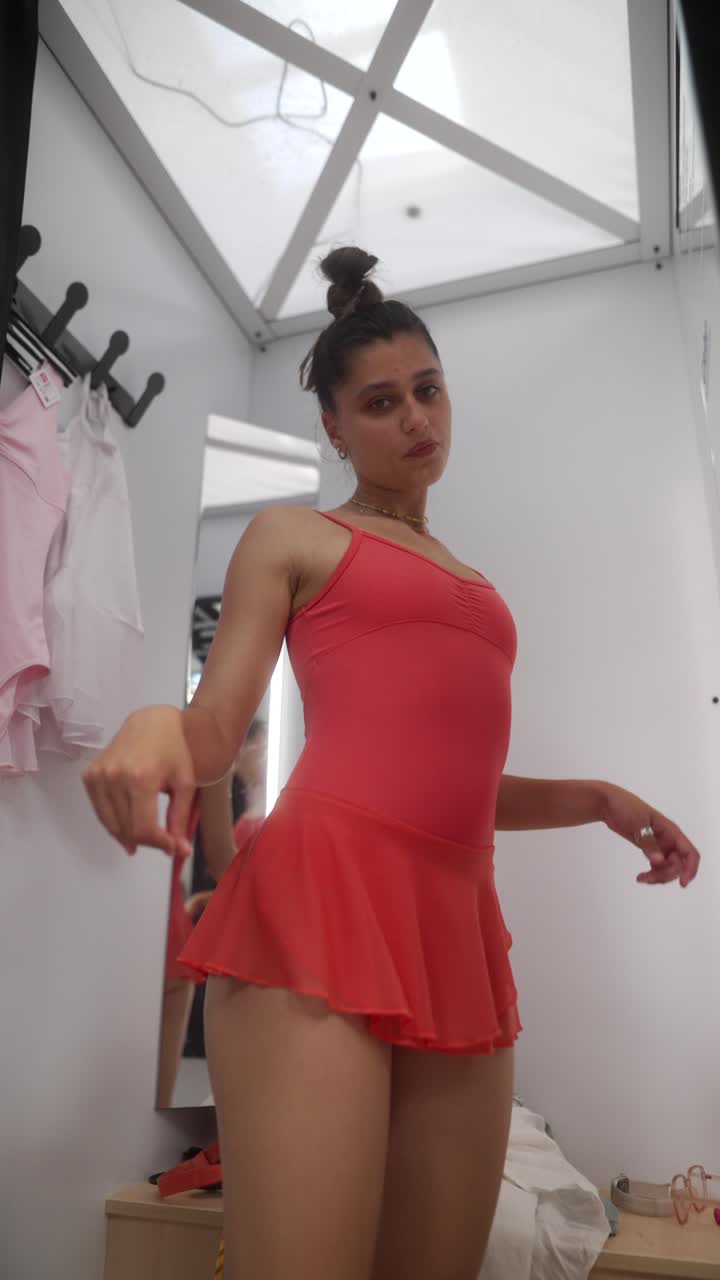 Woman in a changing room trying on a ballet costume
