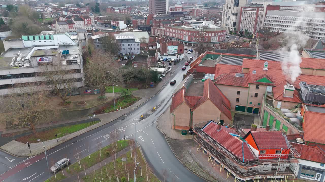 Norwich street with buildings, churches, shops, and a quiet atmosphere, aerial view