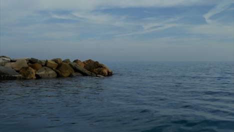 Freedom-concept-of-low-altitude-flight-above-sea-surface-toward-and-over-breakwater