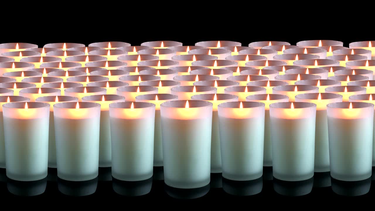 Many white candles on a black background