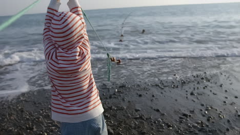 child pulling fishing net at the beach