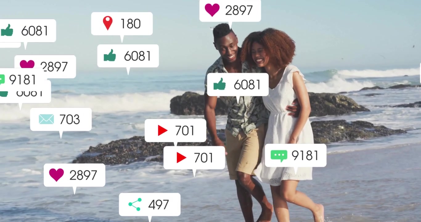 Couple walking arm-in-arm on sunlit rocky shore, activating social media icons growing then fading
