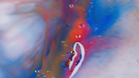 red blue and ocher liquid ink flowing in white color, abstract art