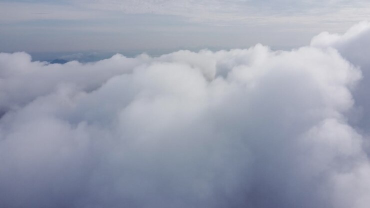White fluffy clouds gently floating in the sky