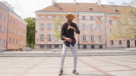 afro caribbean man dancing alone in a public square 2