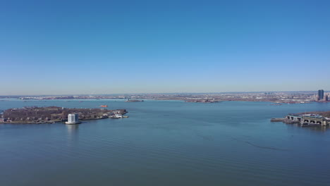 An-aerial-view-the-east-East-River-on-a-sunny-day-with-blue-skies