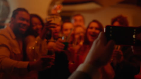 playful people celebrating holiday in bar