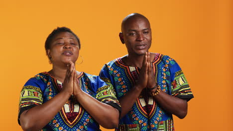 african american people doing prayer hands gesture