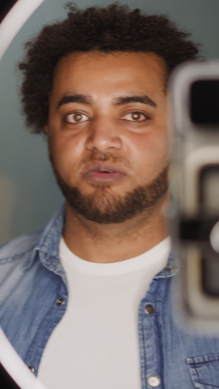 Bearded black man records tutorial about renovation with friend in studio closeup. Black guy drills wall in room. Home restore educative information