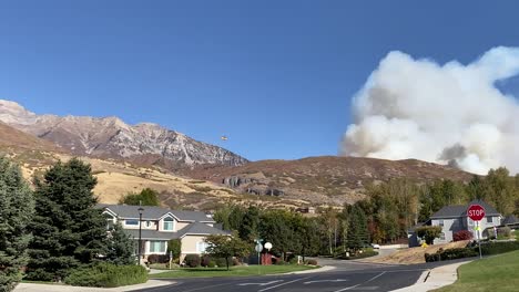 A-helicopter-transports-water-to-dump-on-a-wildfire-in-Lindon,-Utah-and-Provo-Canyon