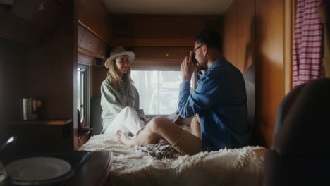 couple taking a picture inside a camper van