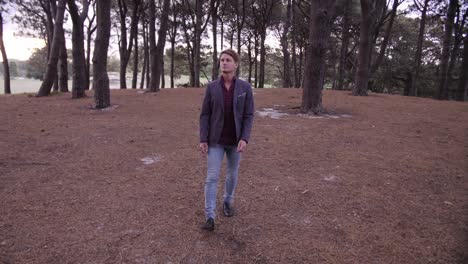 man walking in slow motion with pine tree forest surrounding him