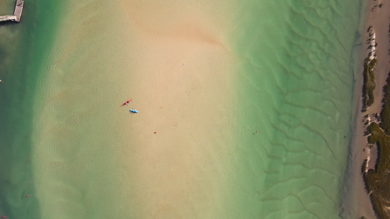 Kayaks and swimmers in clear Goukou estuary, Still Bay