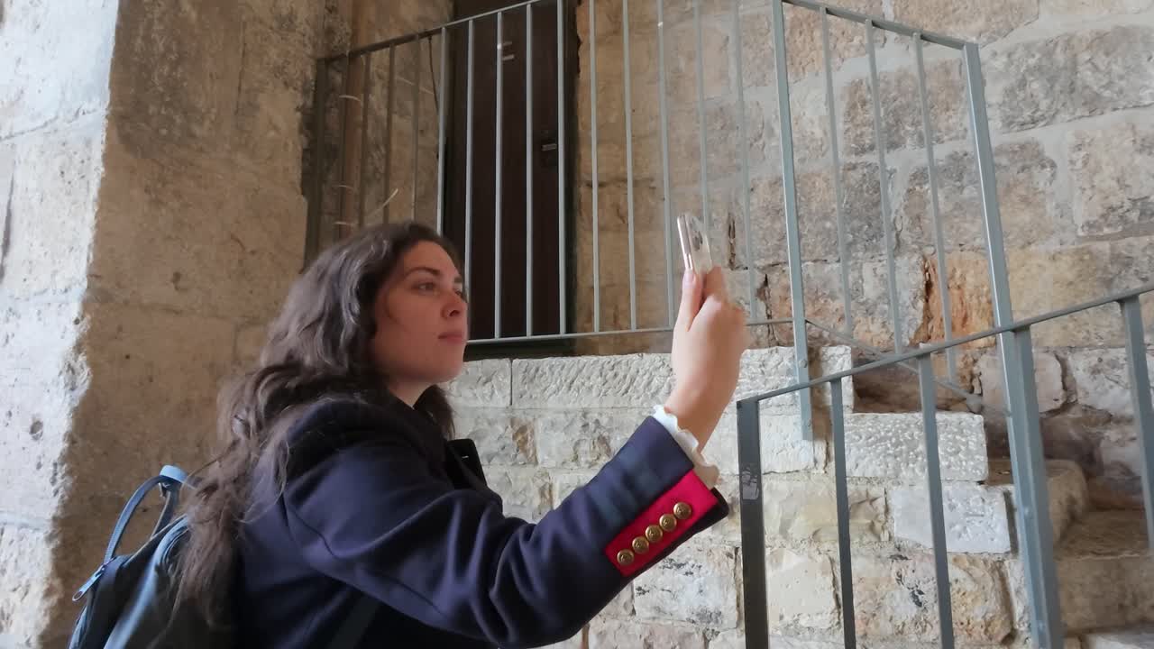 Woman taking a selfie in an old stone building